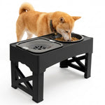 A tan Shiba Inu dog eating from a black dual elevated pet feeder bowl on a white background.