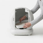 PAWZINA smart litter box showing its automatic waste-cleaning design