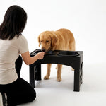 Black and gray adjustable dog feeder displayed from the front