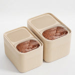 Dog food storage container displayed with included measuring cup