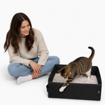 Lightweight portable litter box displayed with its button closure