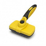 Self-cleaning slicker brush with loose pet fur released from bristles